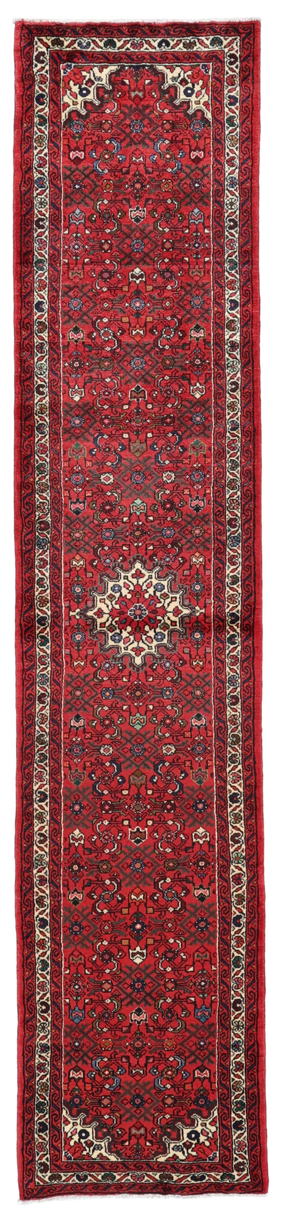 Hand-knotted Hosseinabad runner rug with a vibrant red field, originating from the Middle East.