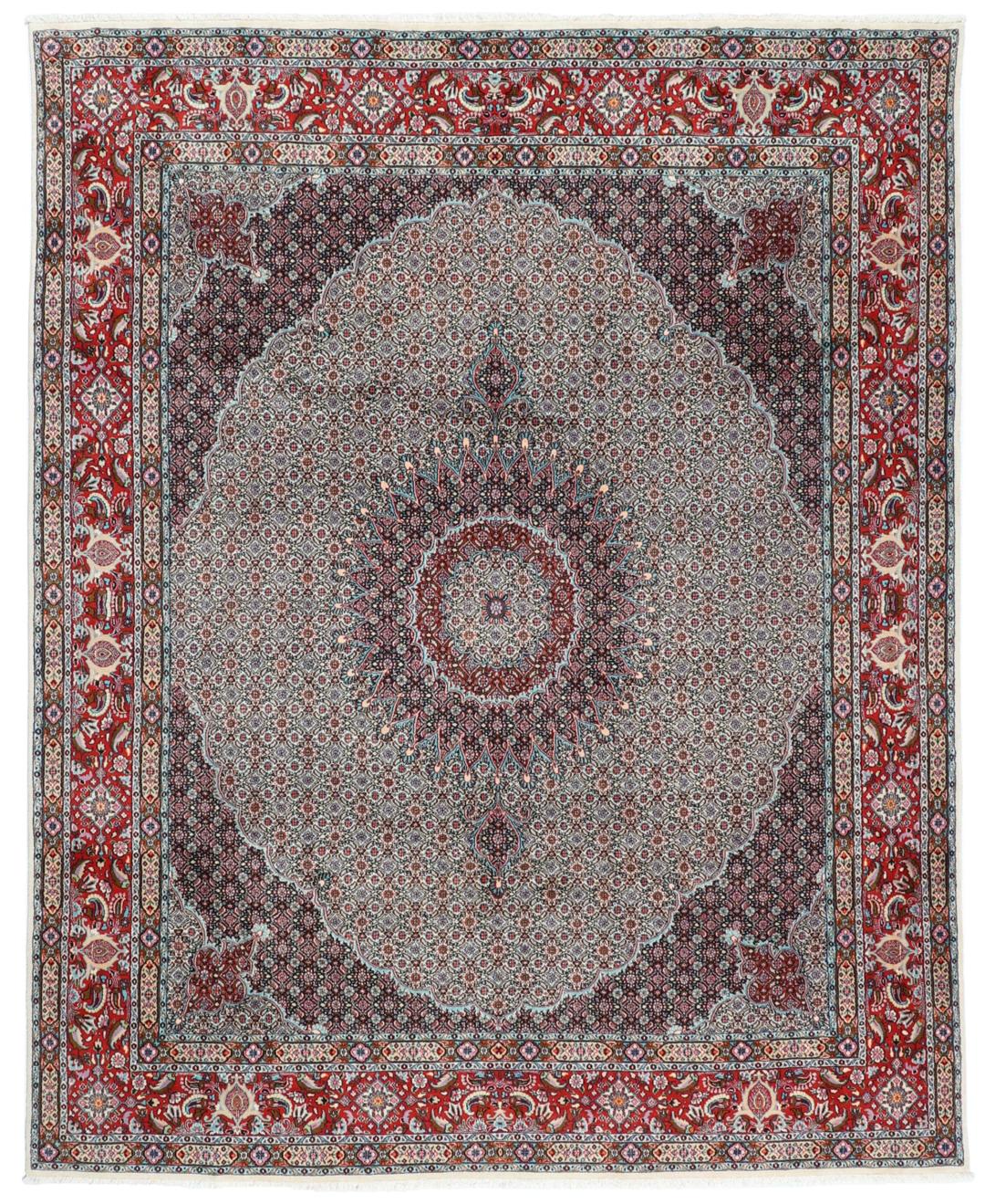 A large rectangular Moud rug from the Middle East featuring a central medallion and ornate floral patterns in multicolor wool.