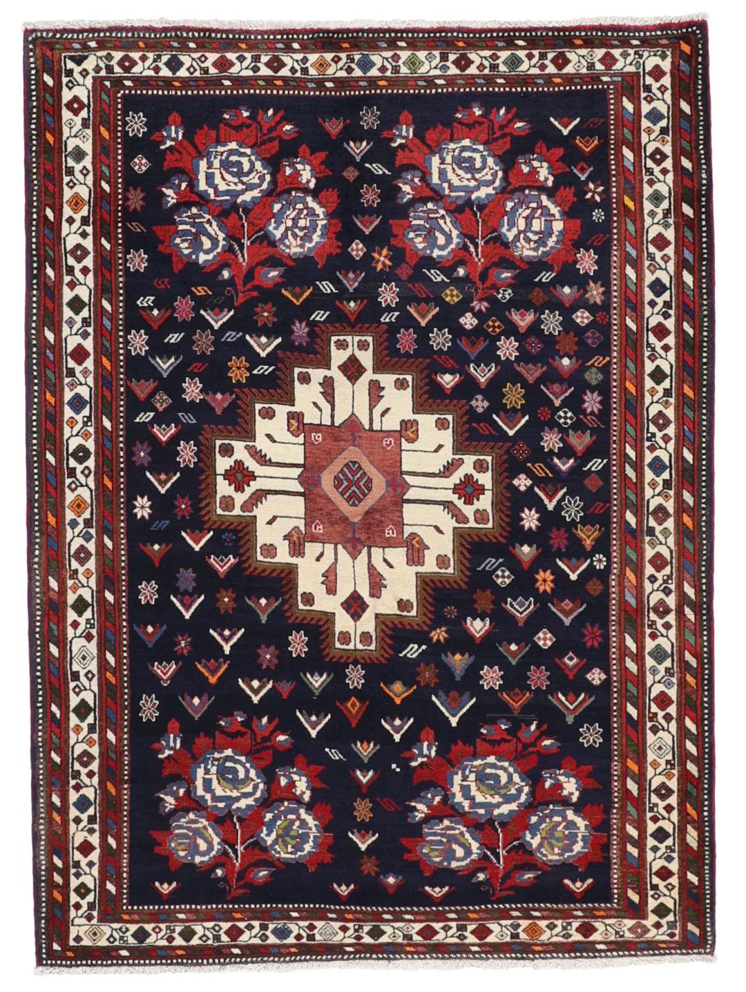 Hand-knotted Sirdjan rug from the Middle East with a dark-blue field and floral medallion pattern.