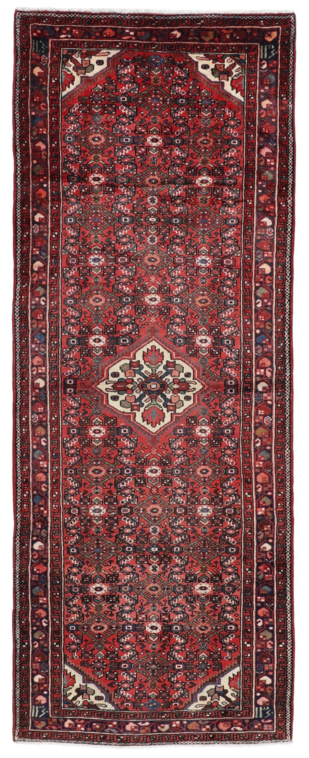 Handmade Hosseinabad runner from the Middle East with a vibrant red Wool pile