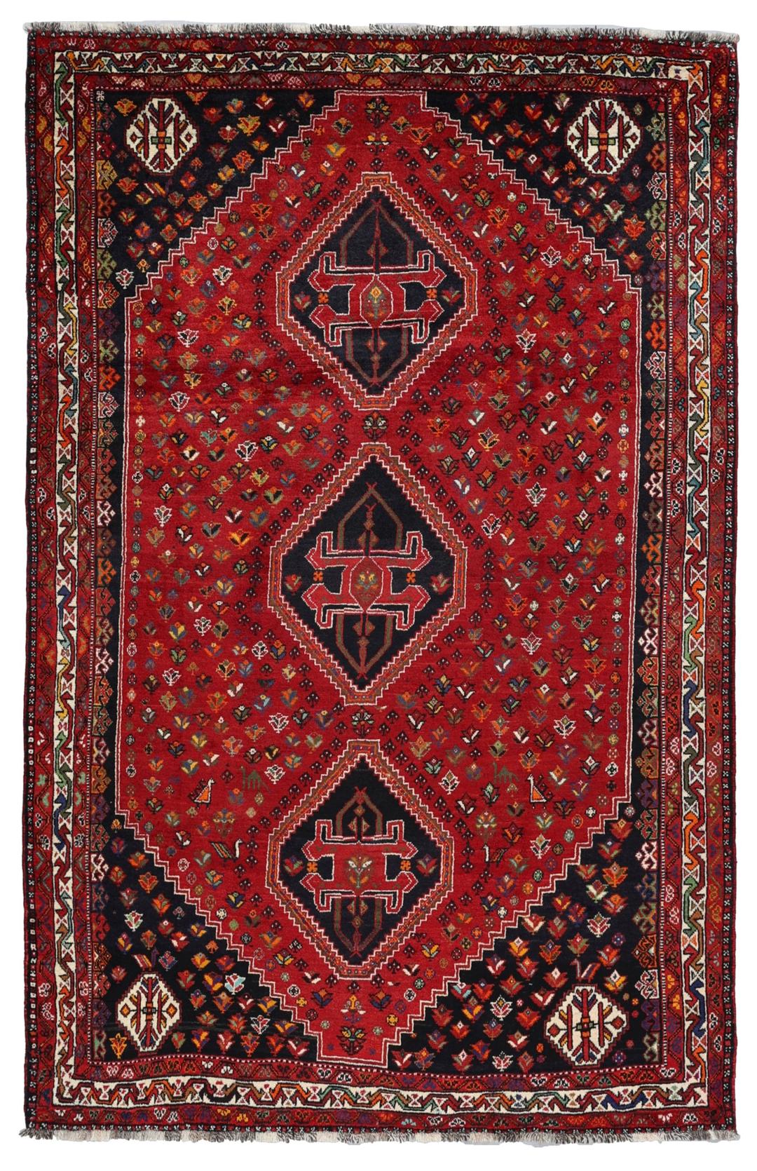 A hand-knotted Shiraz rug from the Middle East featuring a vibrant red field and geometric motifs.