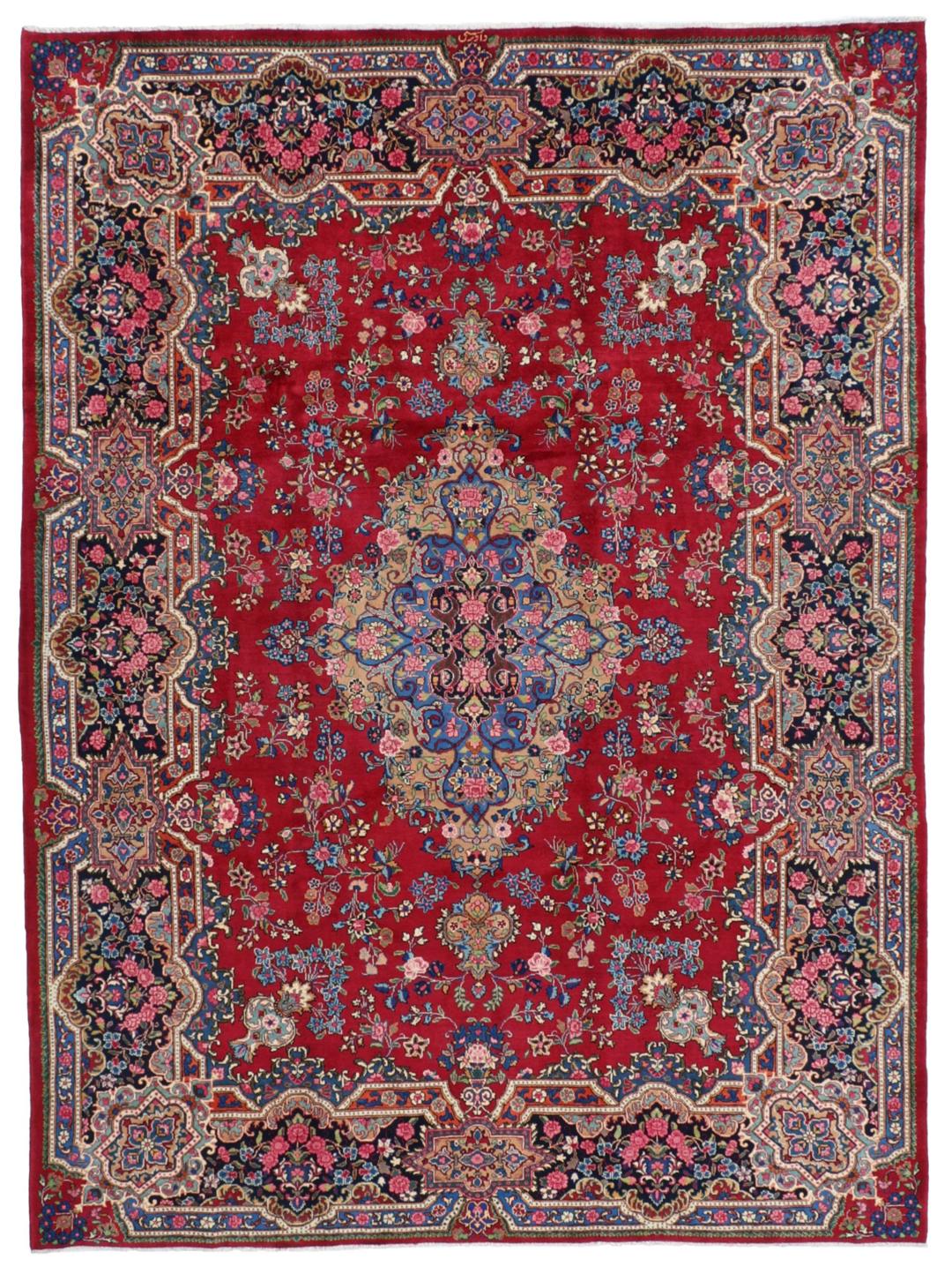 A hand-knotted Mashad rug from the Middle East in dark-red and blue tones.