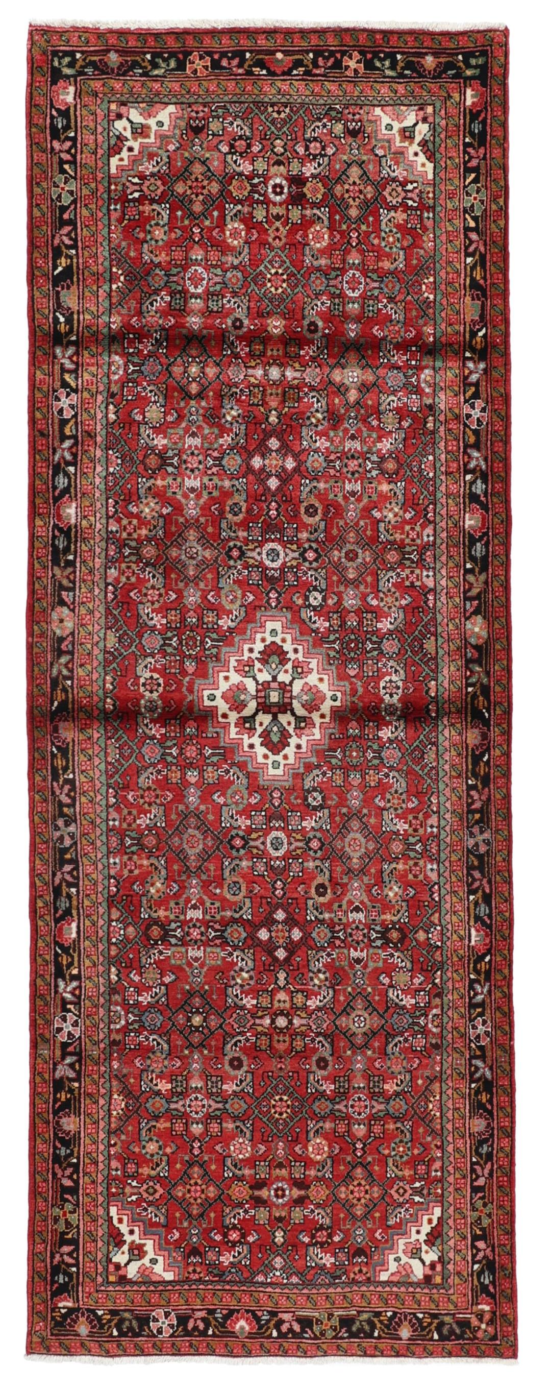 Hand-knotted Hosseinabad runner in red from the Middle East