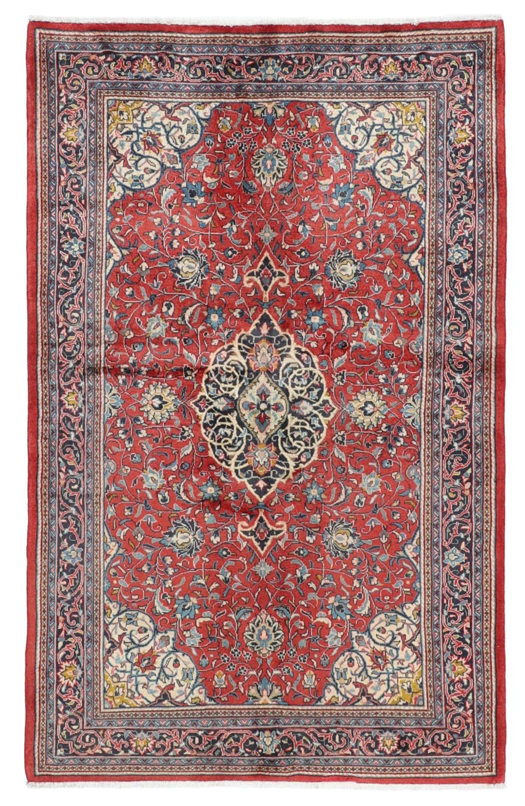 Hand-knotted Sarough rug from the Middle East with a red field and floral patterns.
