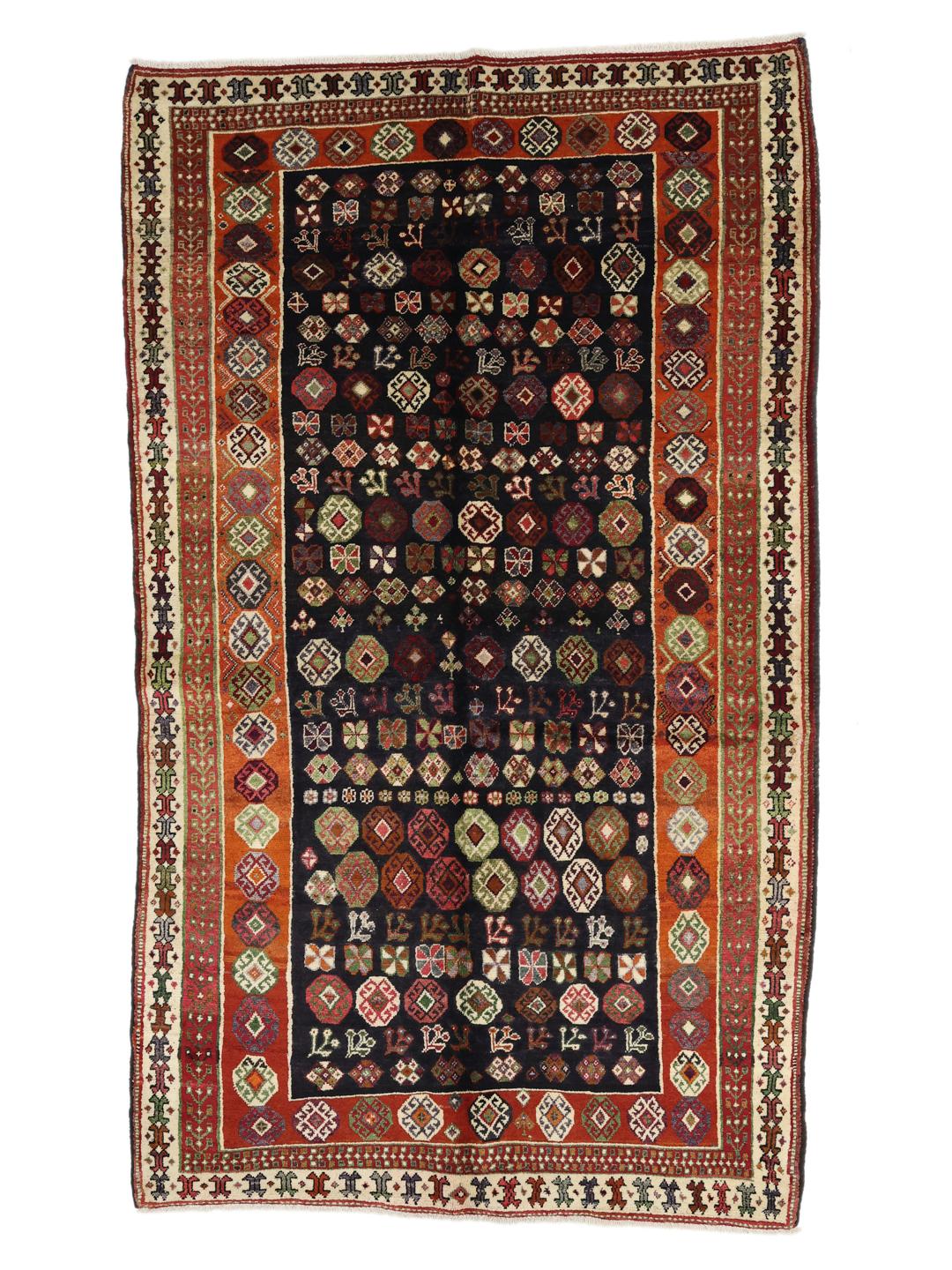 Hand-knotted Ghashghai rug from the Middle East with a dark blue and red colour palette