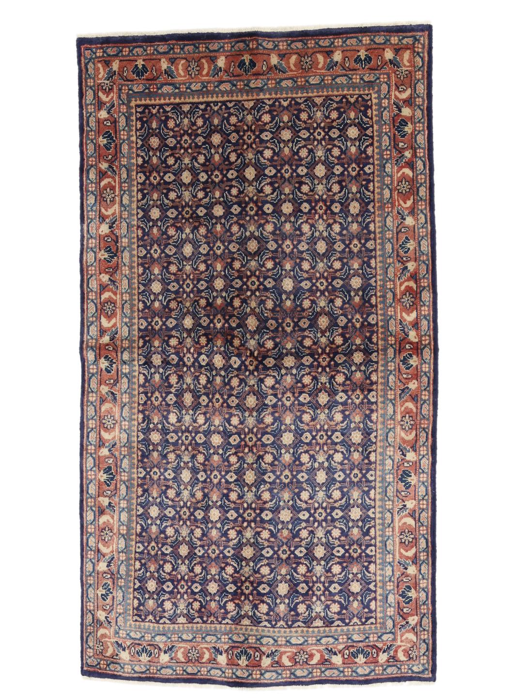 A hand-knotted Sarough rug from the Middle East with a deep blue floral pattern