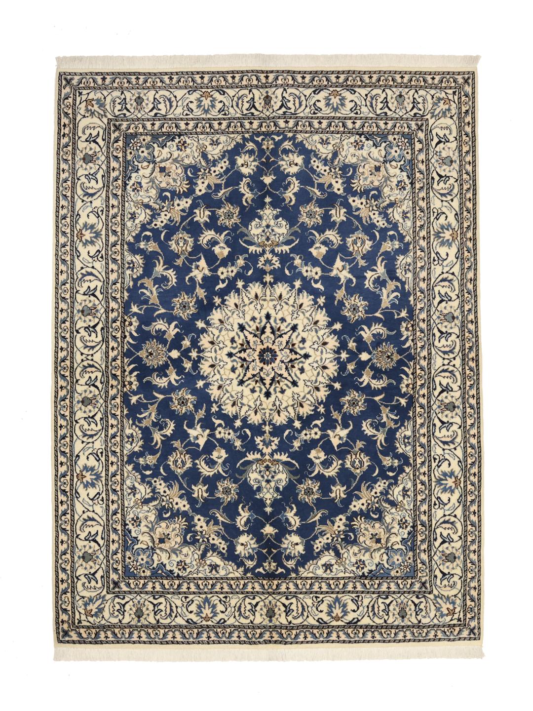 A hand-knotted Nain rug from the Middle East featuring a deep blue field with floral patterns.
