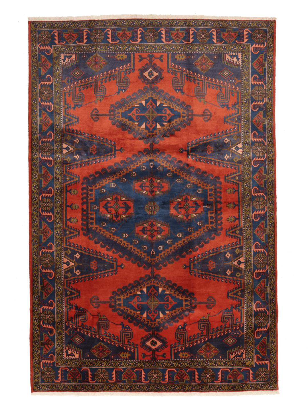Een handgeknoopt Wiss-tapijt uit het Midden-Oosten met een gedurfd rood en blauw geometrisch patroon.