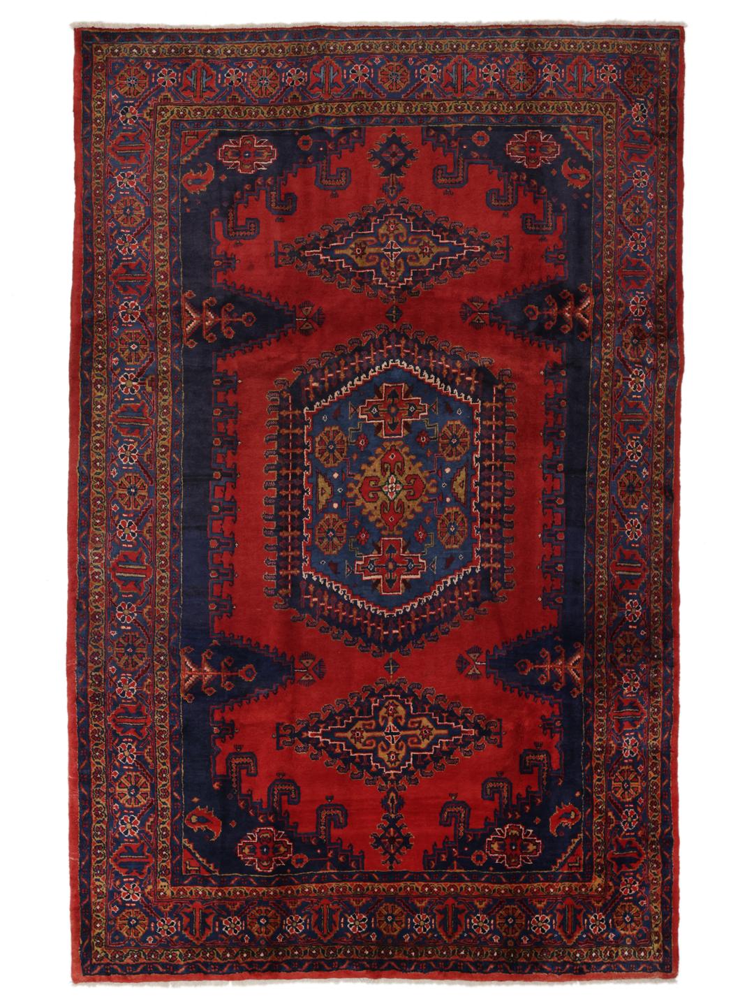 Een handgeknoopt Wiss tapijt uit het Midden-Oosten met een levendig rood en blauw geometrisch patroon.
