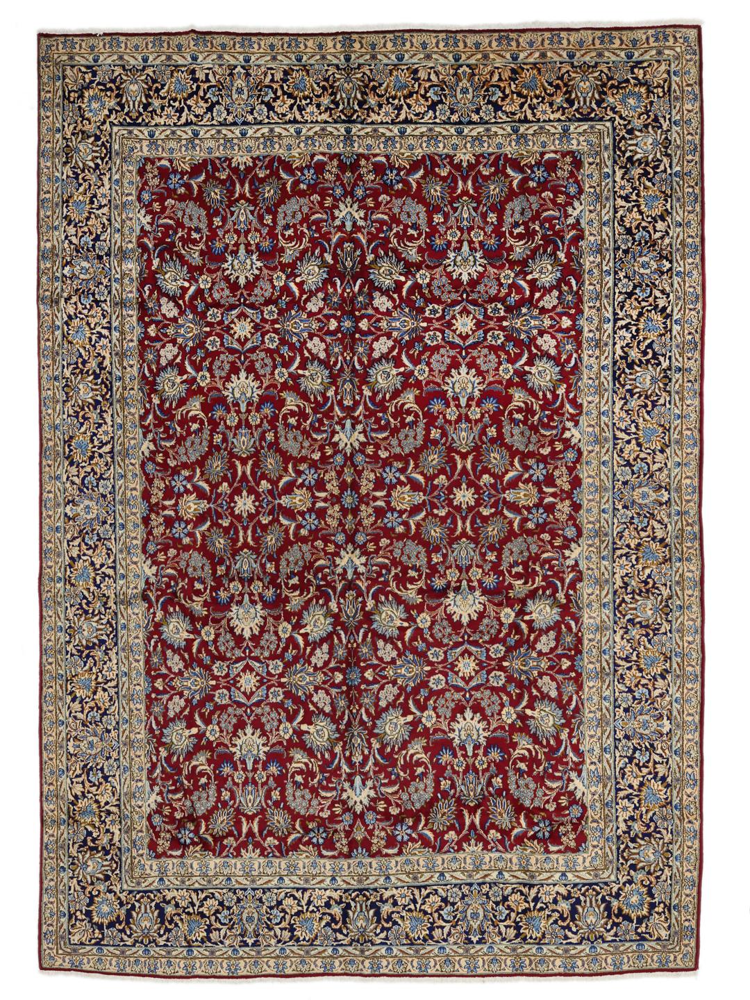 A hand-knotted Kerman rug from the Middle East featuring a vibrant red field and intricate floral patterns.