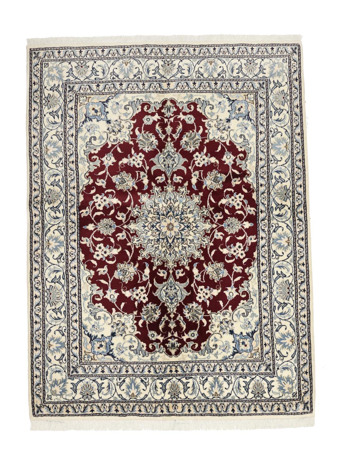 Hand-knotted Nain rug from the Middle East featuring a dark-red and blue floral medallion design.