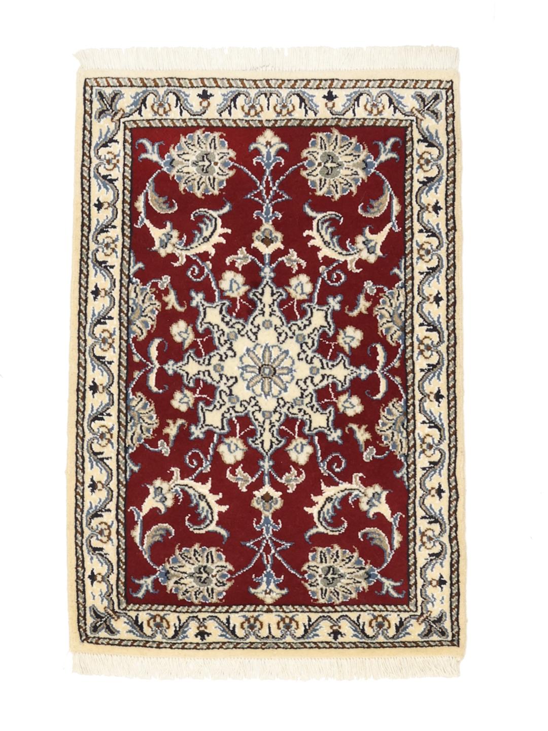 Hand-knotted Nain rug from the Middle East in dark-red with floral motifs.