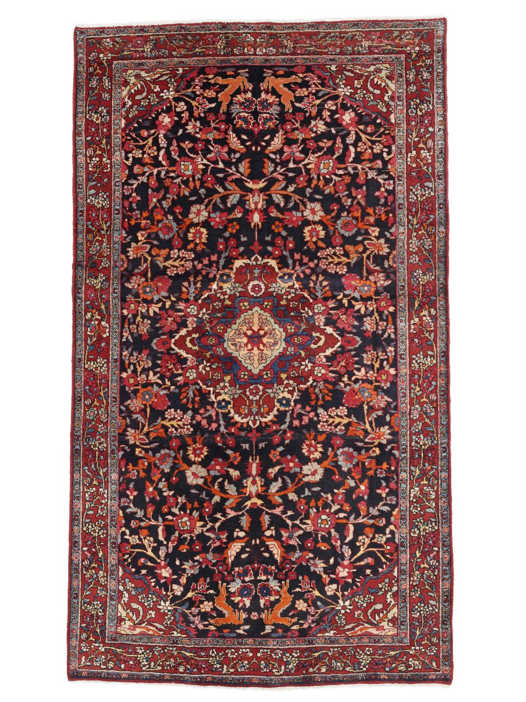 A hand-knotted Hamadan rug from the Middle East with a dark-blue and red floral design.