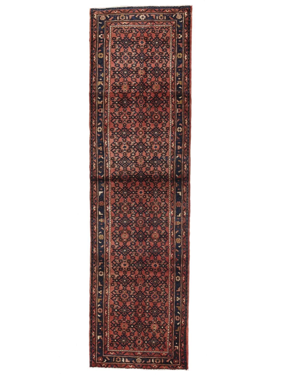 A hand-knotted Hosseinabad runner from the Middle East featuring a red and dark blue geometric pattern.
