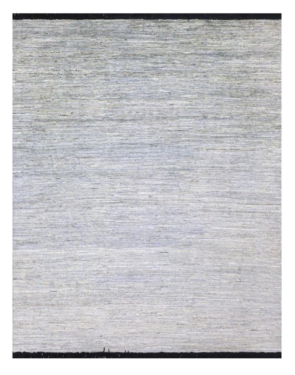 Een minimalistisch, handgeknoopt grijs wollen tapijt uit Afghanistan.
