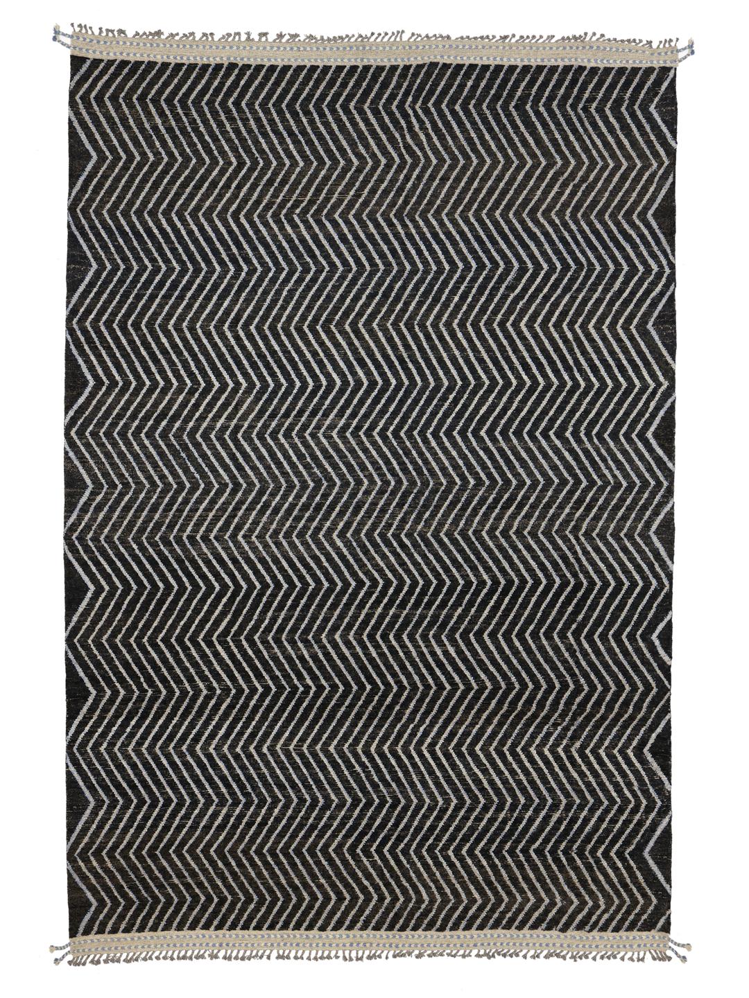 A large hand-knotted rug from Afghanistan with a monochrome zig-zag pattern