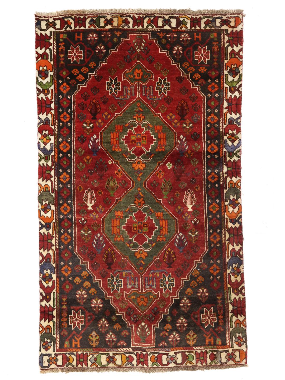 Hand-knotted Shiraz rug from the Middle East featuring a vibrant red and green geometric design.