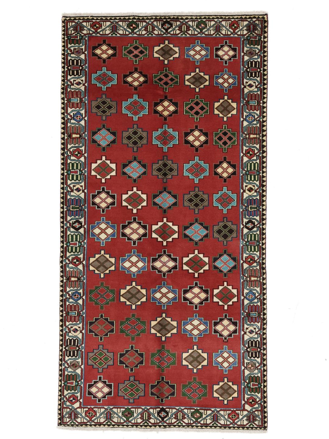 A hand-knotted Shiraz rug from the Middle East in a deep red colour with geometric patterns.