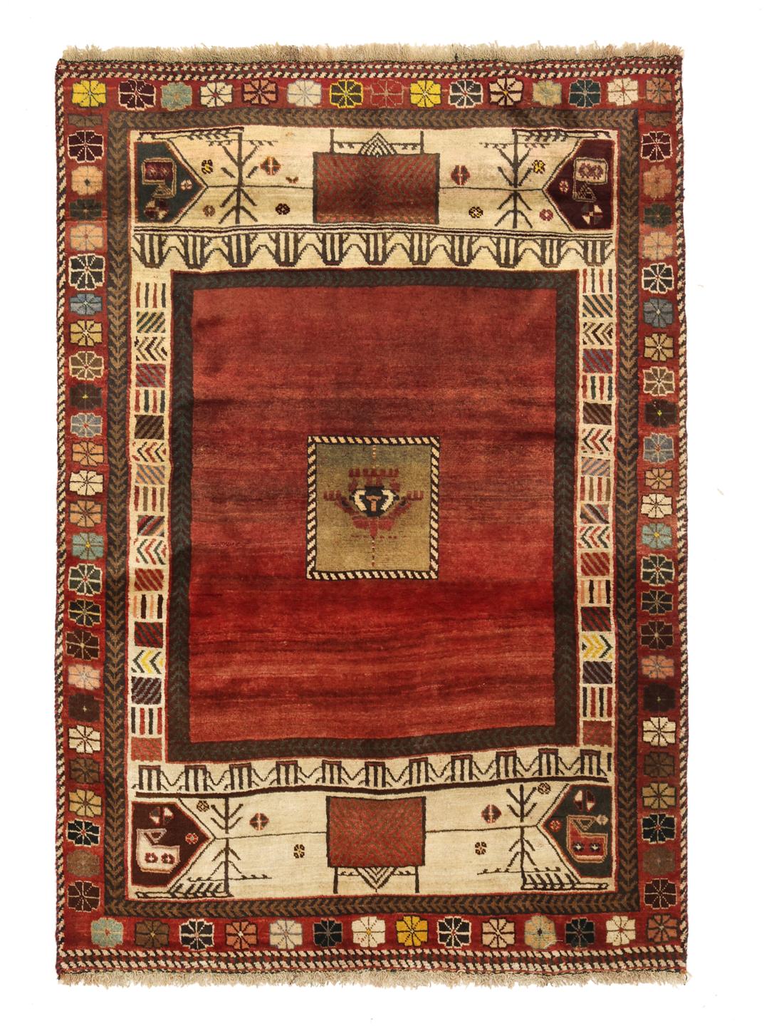 A hand-knotted Shiraz rug from the Middle East featuring a vibrant red field and tribal motifs.
