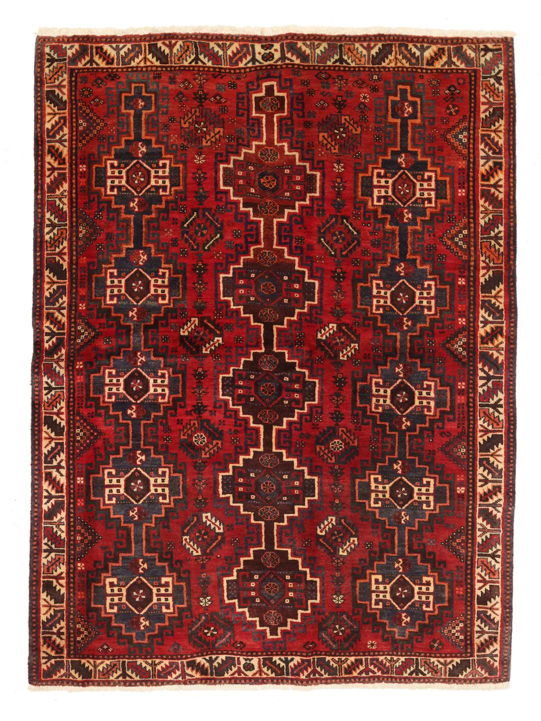 A hand-knotted Shiraz rug from the Middle East featuring a vibrant red field and bold geometric medallion patterns.