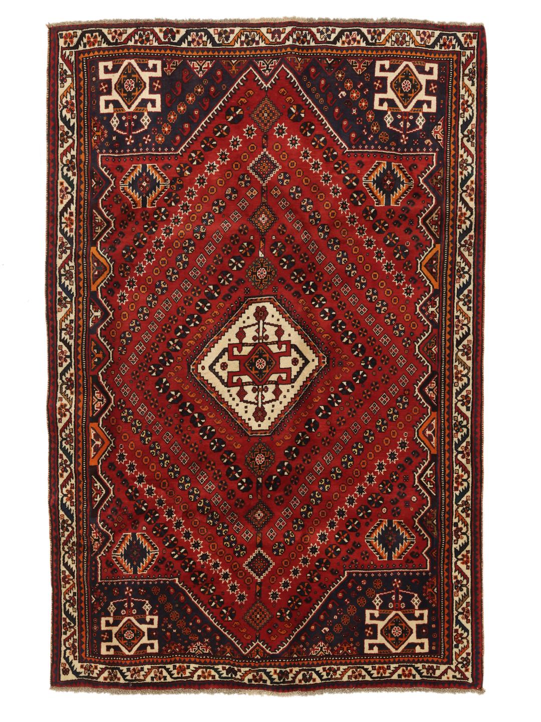 Hand-knotted Qashqai rug from the Middle East featuring a dark-red field and geometric patterns.