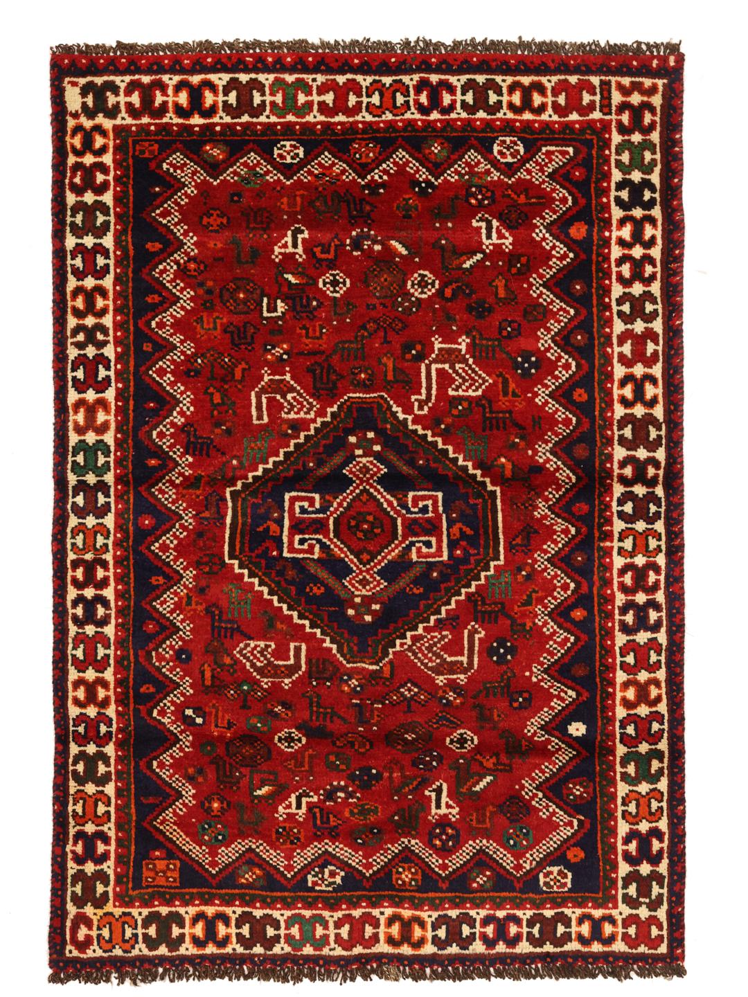 Hand-knotted Shiraz rug from the Middle East featuring a vibrant red field and tribal motifs