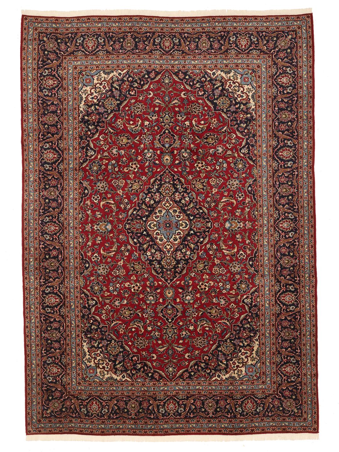 A hand-knotted red Keshan rug from the Middle East with a floral medallion pattern.