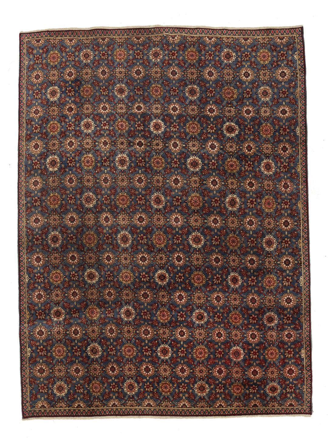 Hand-knotted Sarouk rug from the Middle East featuring a blue field with floral motifs.