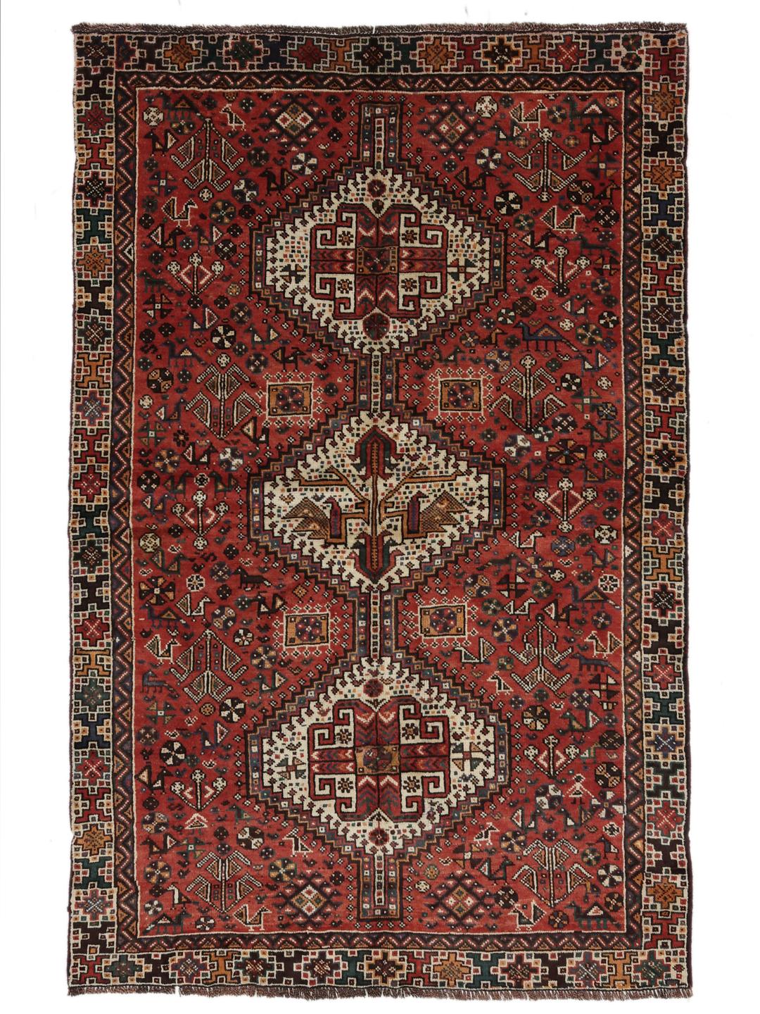 Hand knotted Shiraz rug from the Middle East featuring a vibrant red field with geometric medallions