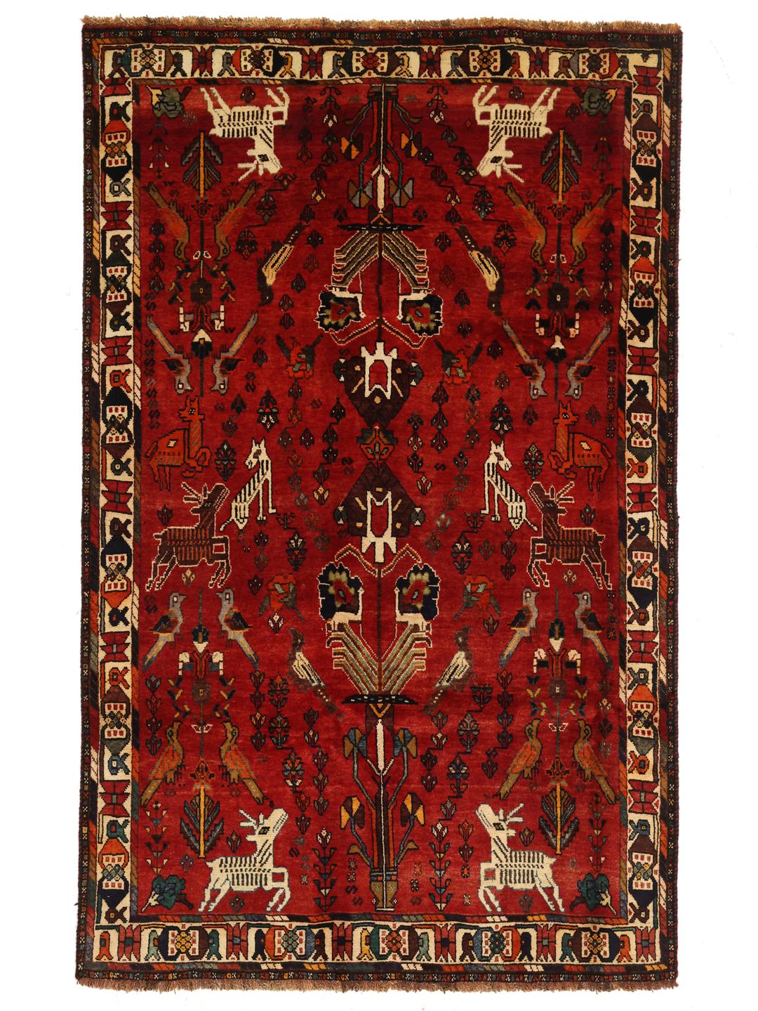 A unique hand-knotted Ghashghai rug from the Middle East with a vibrant red field and animal motifs.