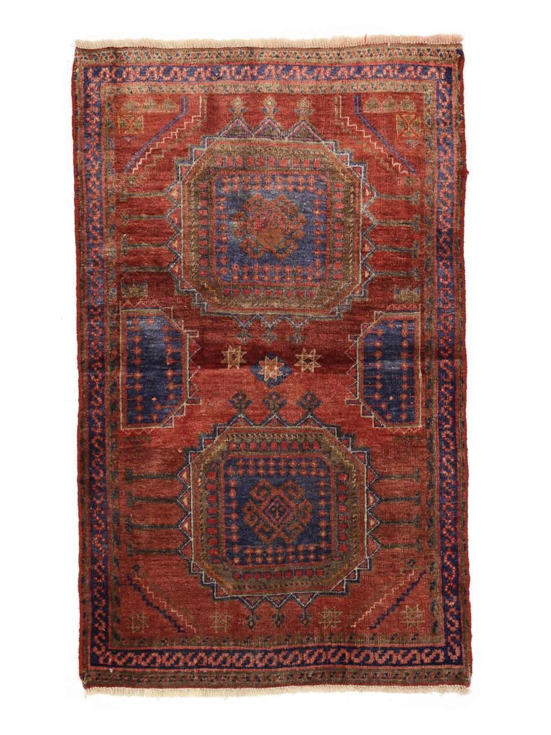 Hand-knotted red rug from the Middle East with a unique patina finish