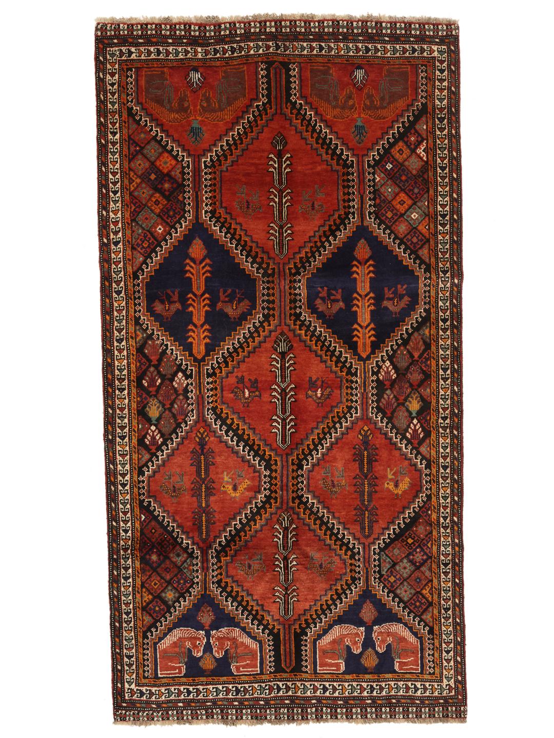 A hand-knotted Qashqai rug from the Middle East featuring a vibrant red and blue geometric pattern.