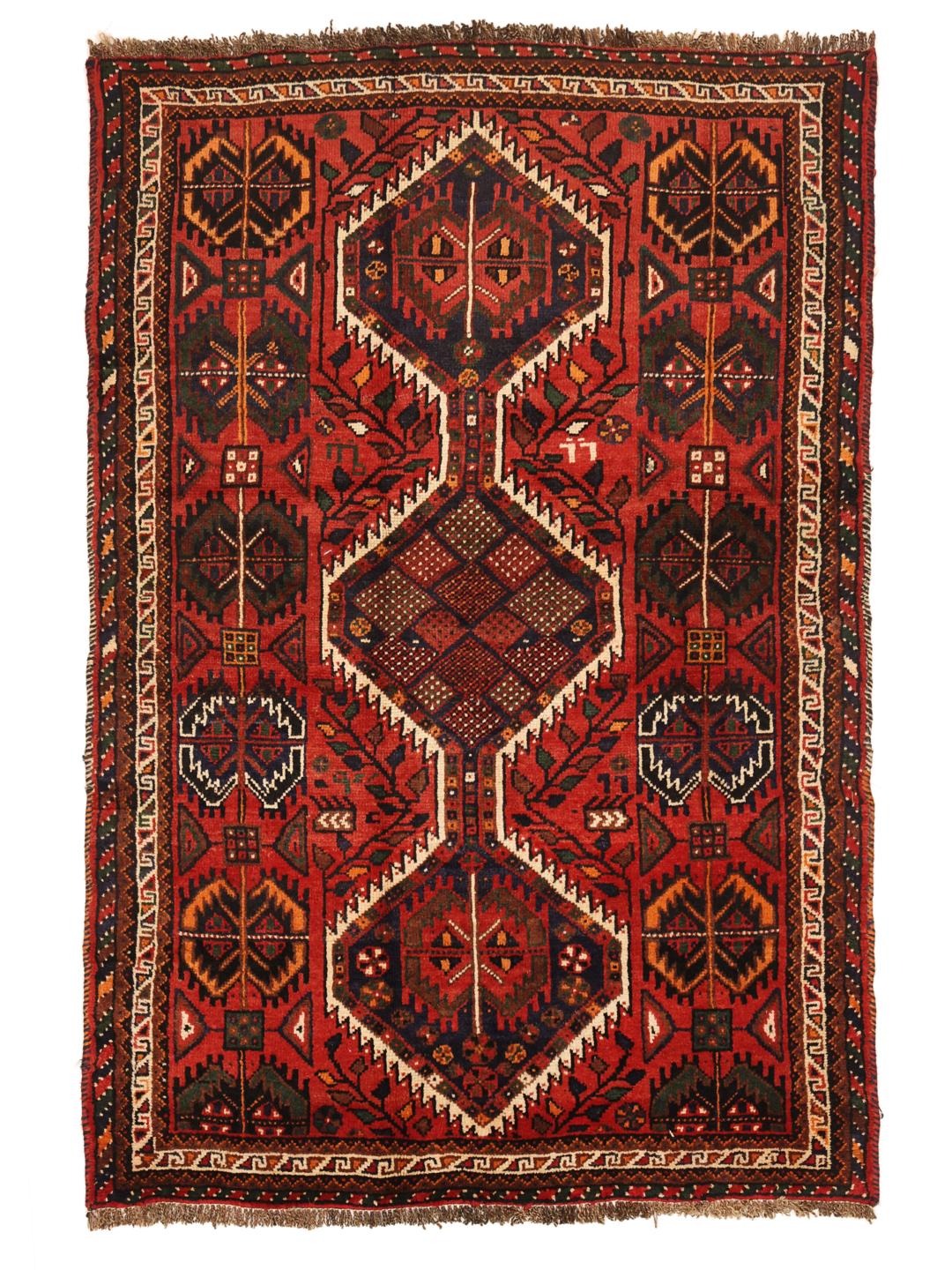 Hand-knotted Shiraz rug from the Middle East featuring a vibrant red field and tribal geometric patterns.