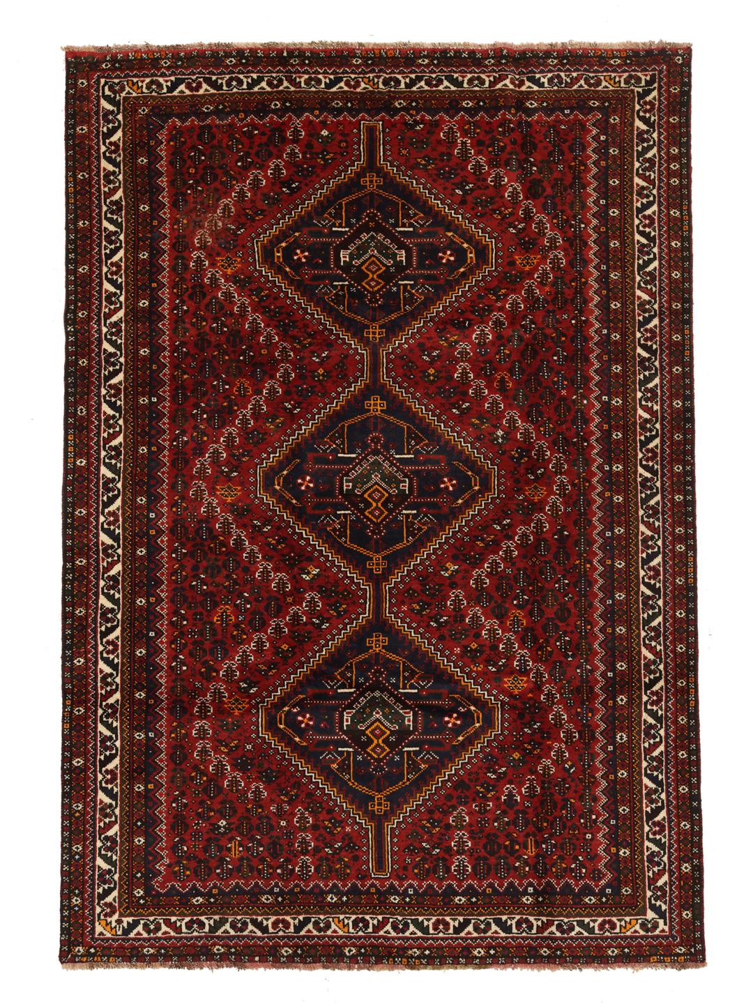 A hand-knotted Shiraz rug from the Middle East featuring a dark-red field with geometric medallions.