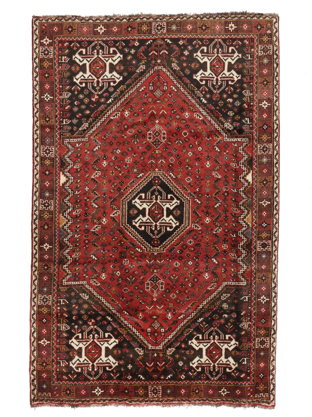 Hand-knotted Ghashghai rug from the Middle East featuring a vibrant red and black palette
