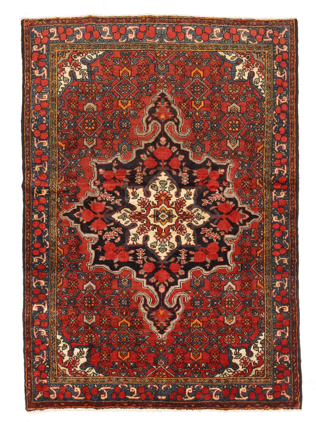 A hand-knotted Hosseinabad wool rug from the Middle East featuring a red field and central medallion.
