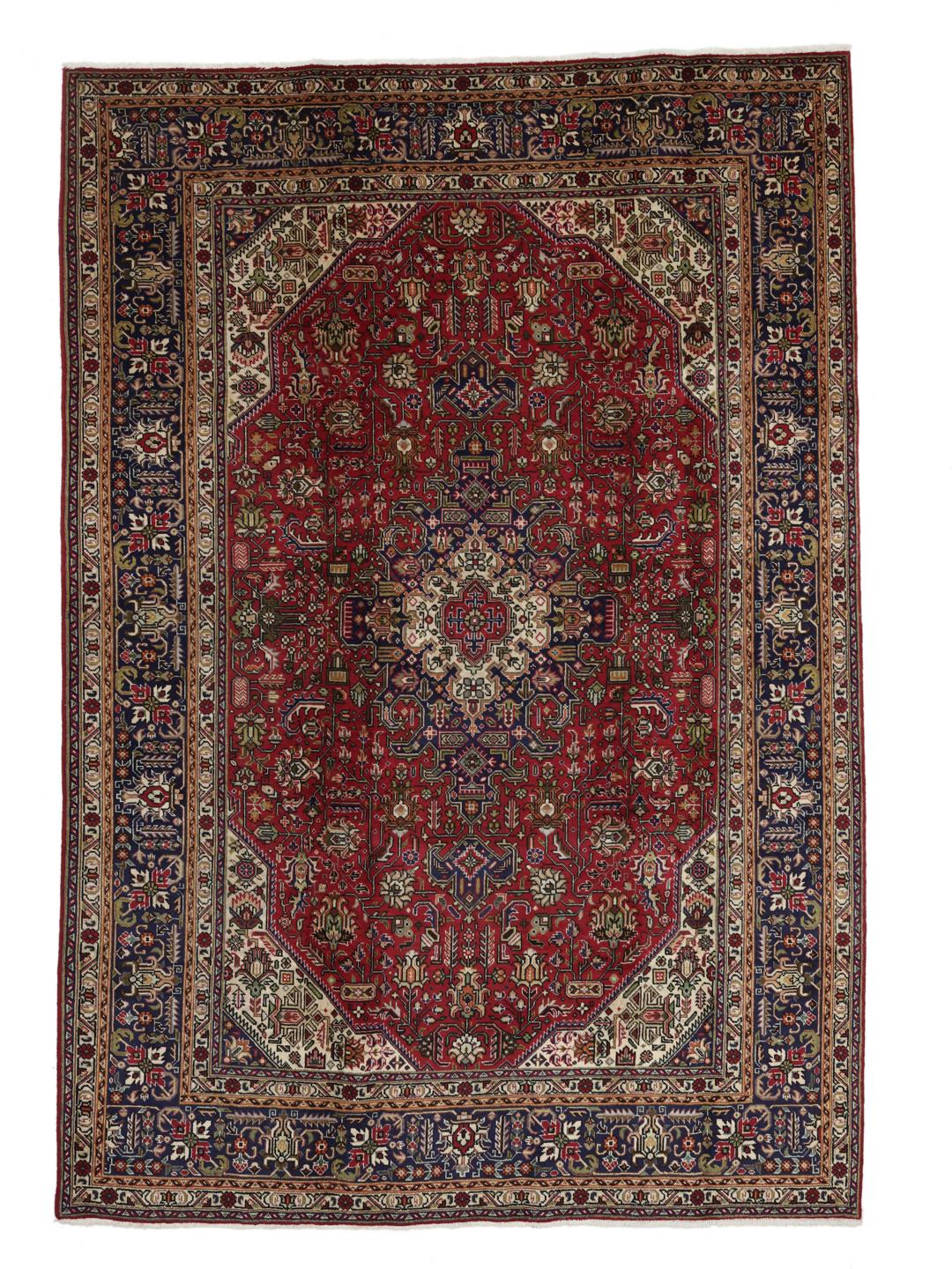 Handmade Tabriz rug from the Middle East featuring a red and blue floral medallion pattern