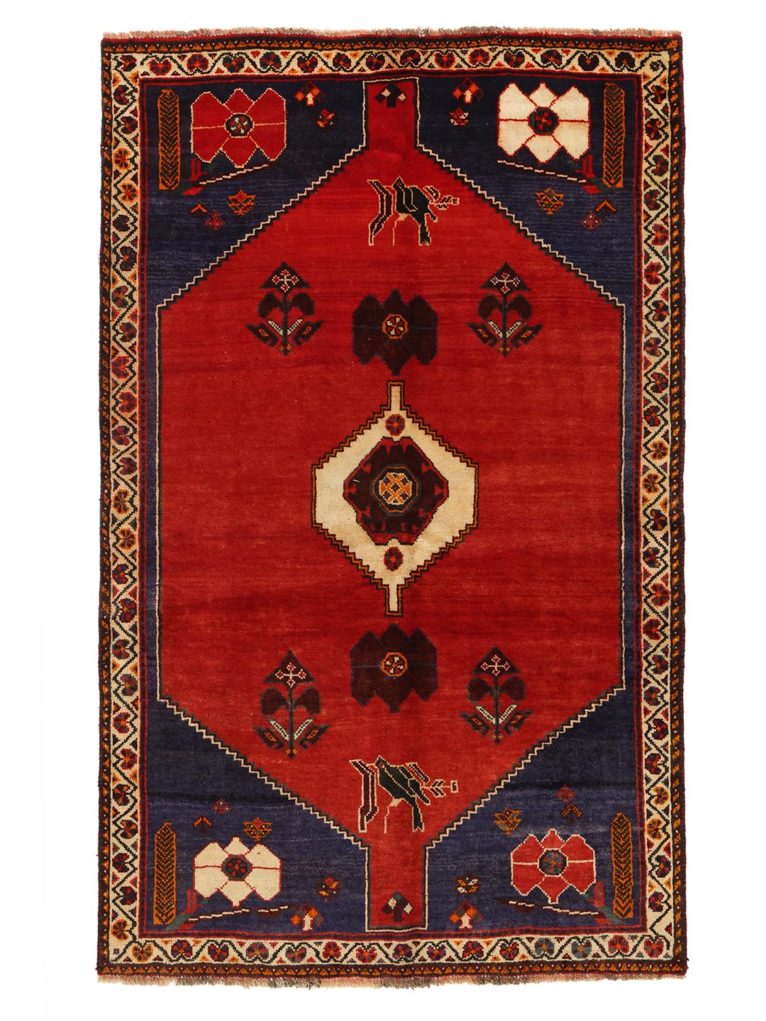 Hand-knotted Qashqai rug from the Middle East in red and deep blue tones