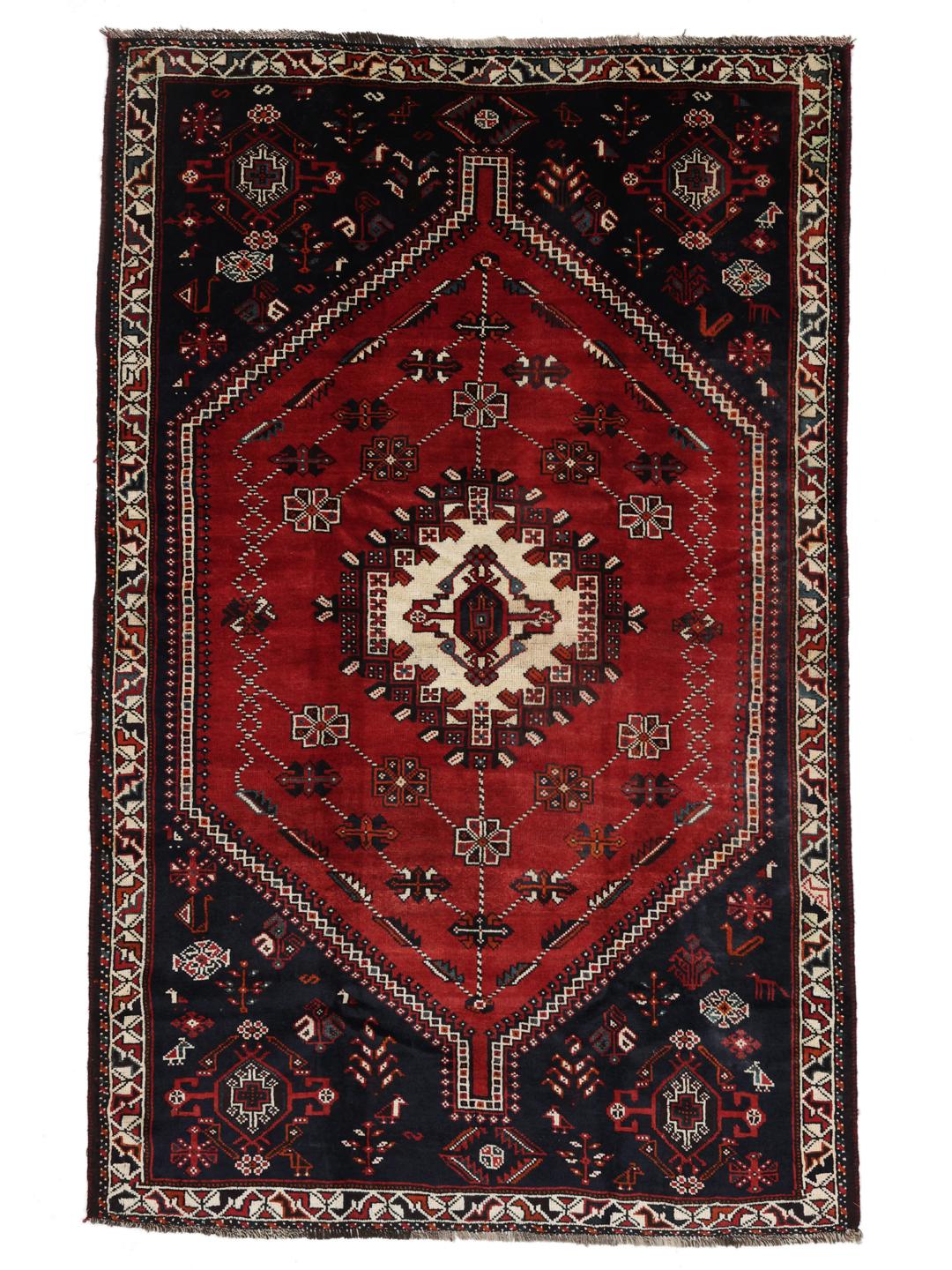 Hand-knotted Middle Eastern rug with red and black geometric patterns