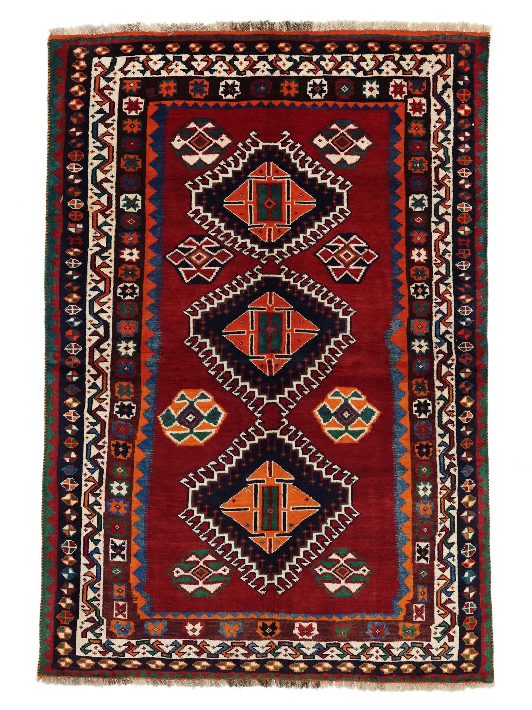 Hand-knotted Qashqai rug from the Middle East with a red field and geometric patterns