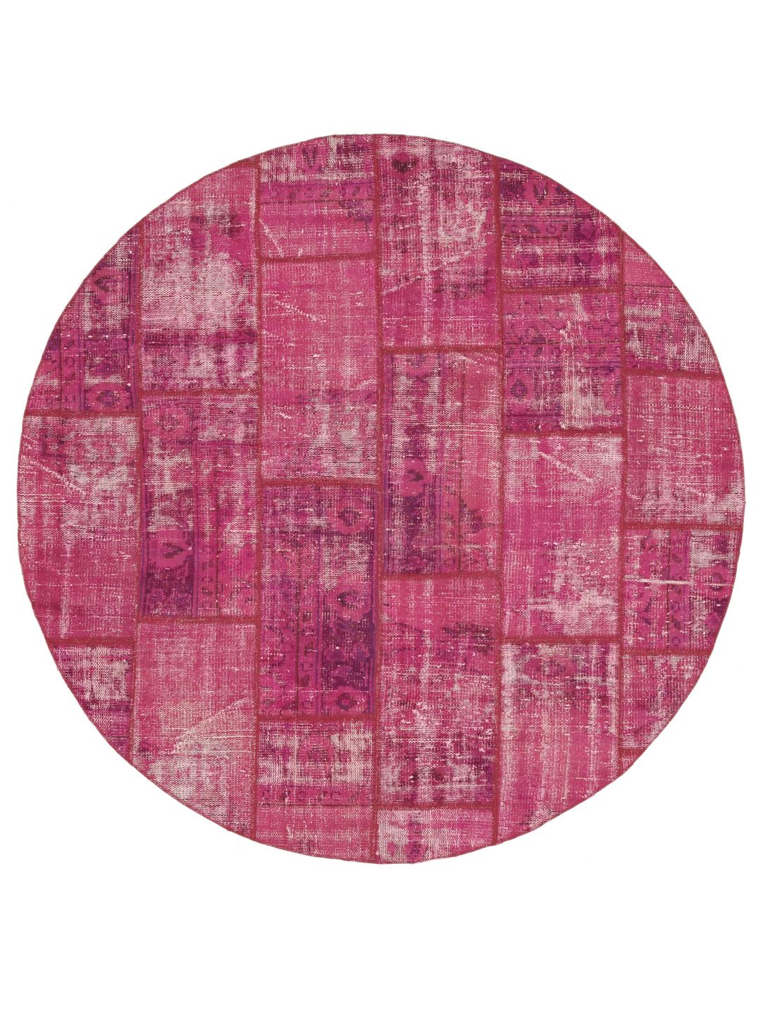 Et rundt, levende pink patchworktæppe med et geometrisk layout, der stammer fra Mellemøsten.