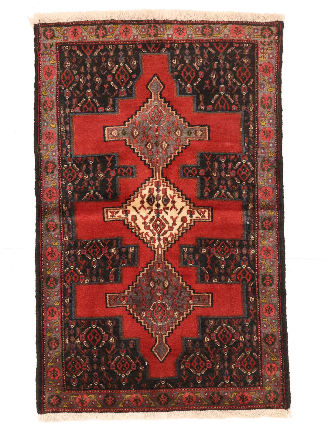 A hand-knotted Senneh rug from the Middle East with a bold red and black geometric design.
