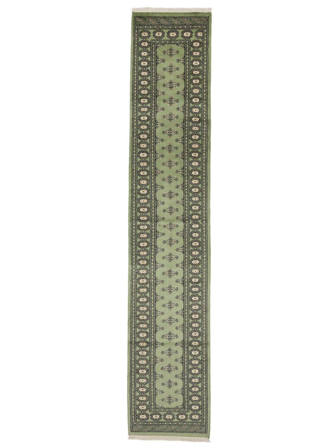 A long, elegant Pakistan Bokhara runner in soft green with traditional motifs.