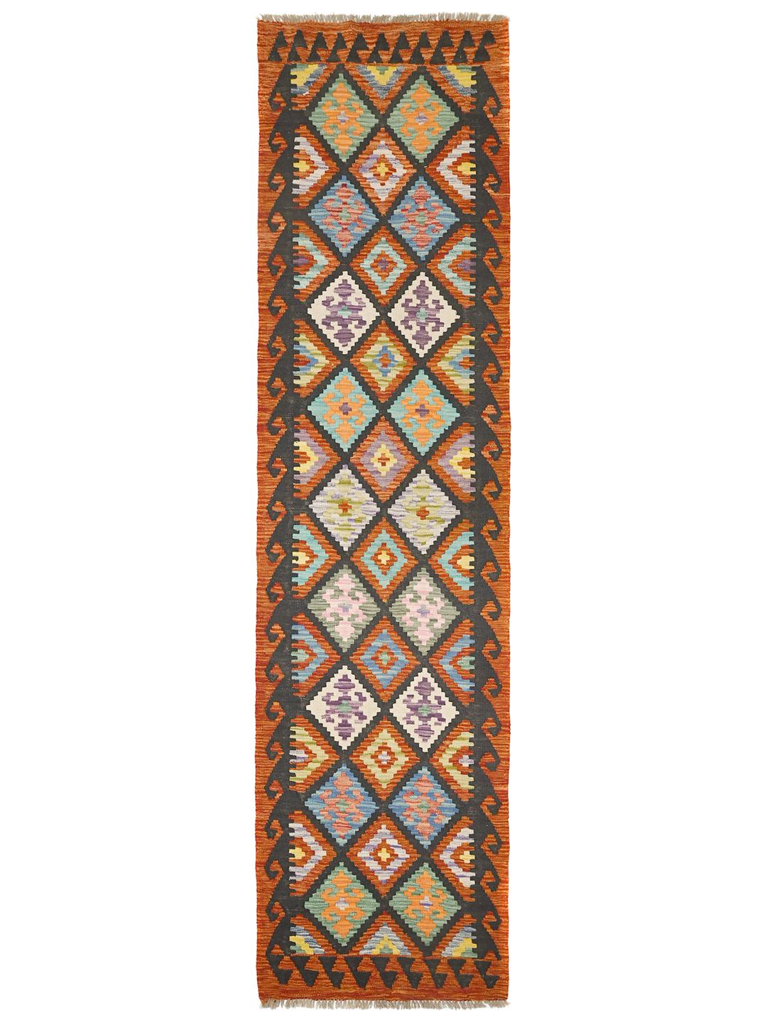 A vibrant Afghan Kelim runner with a geometric diamond pattern in multicolor wool.