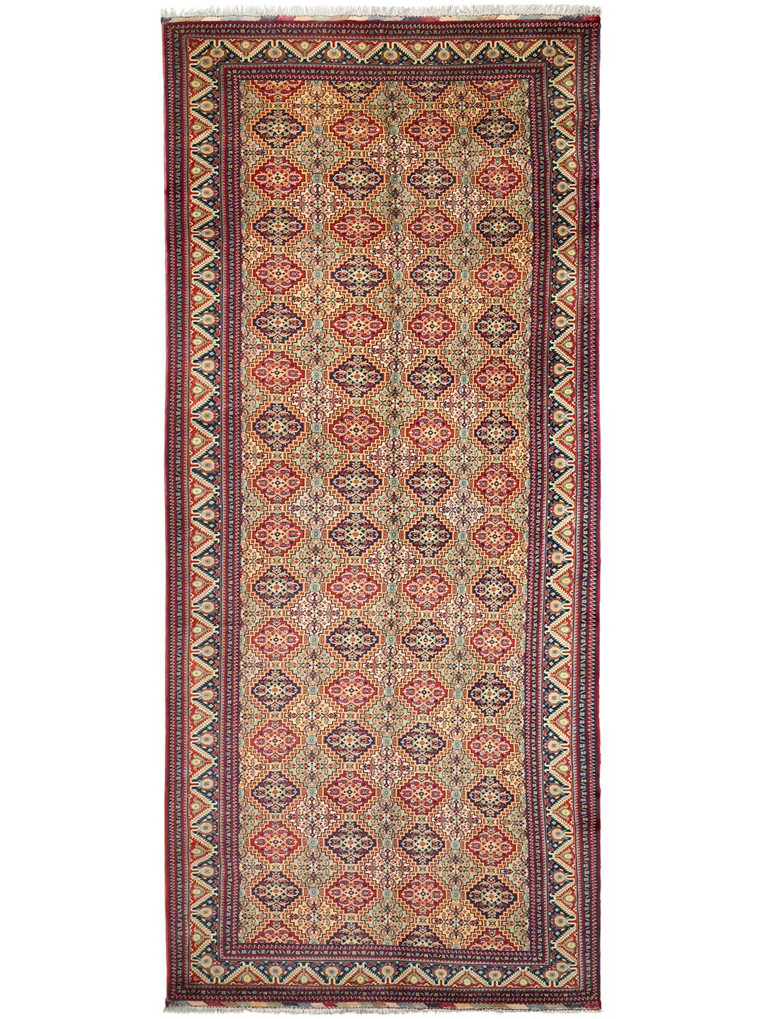 Handmade runner rug from Afghanistan in red with traditional patterns.