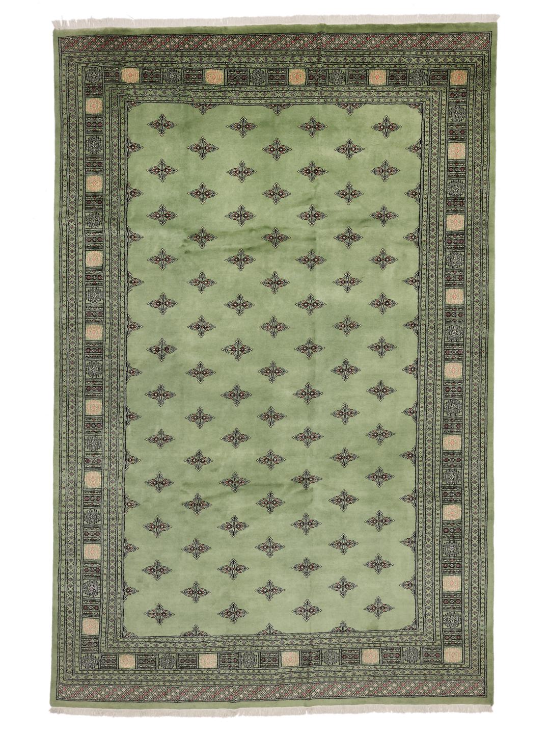 Hand-knotted Bokhara rug from Pakistan with a soft green field