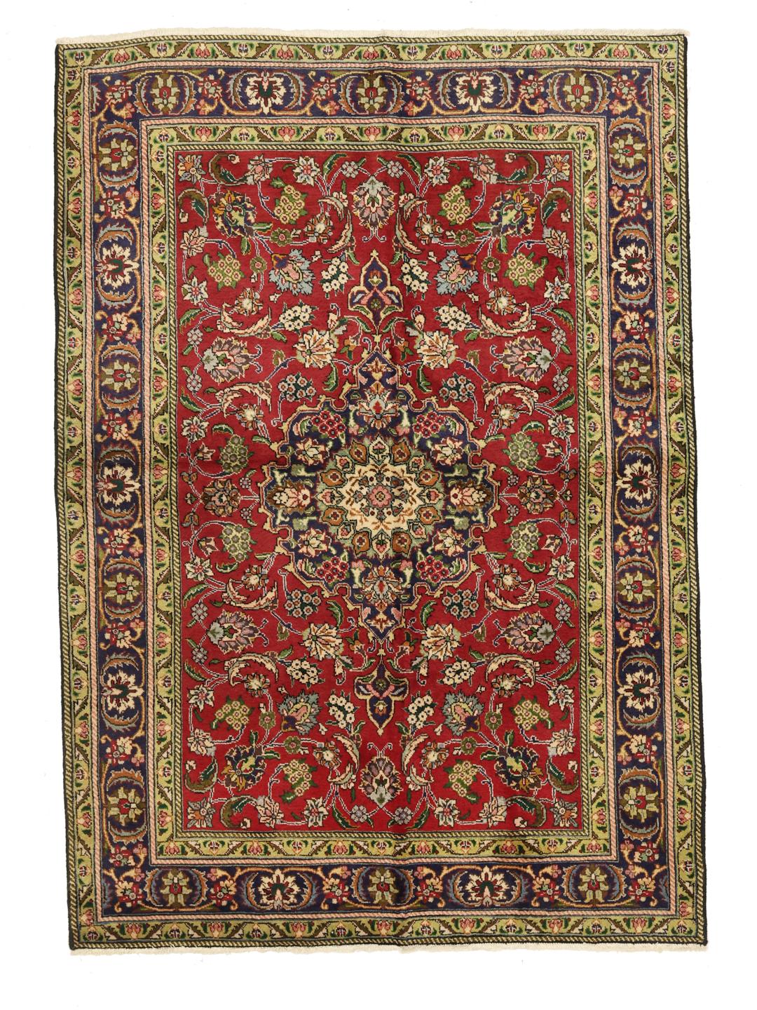 A hand-knotted Tabriz rug from the Middle East featuring a vibrant red field with a blue central medallion.