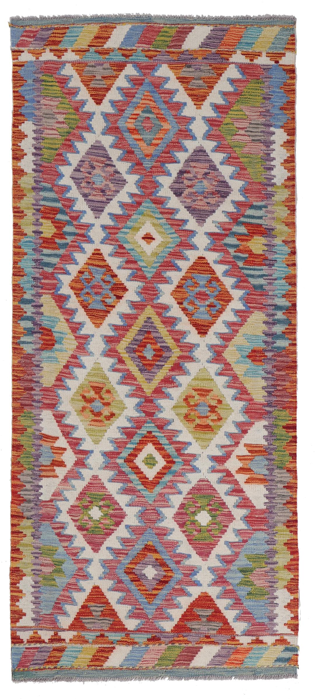 A hand-woven Afghan runner rug with a multicolor diamond pattern on a light background