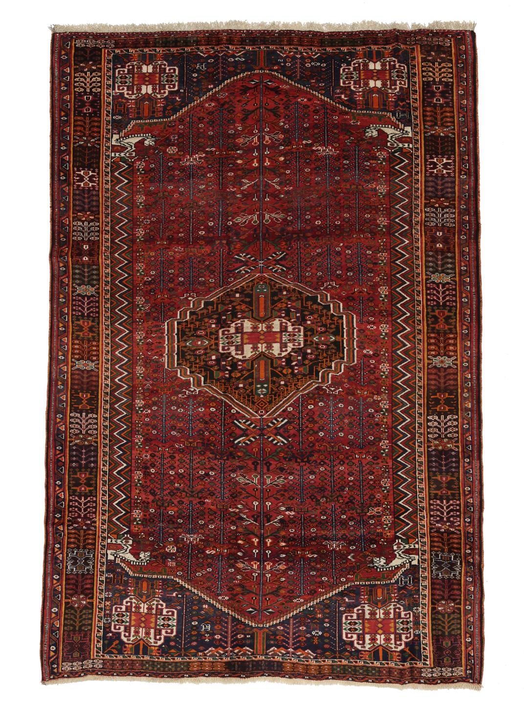 Hand-knotted Shiraz rug from the Middle East featuring a vibrant red field with geometric motifs.