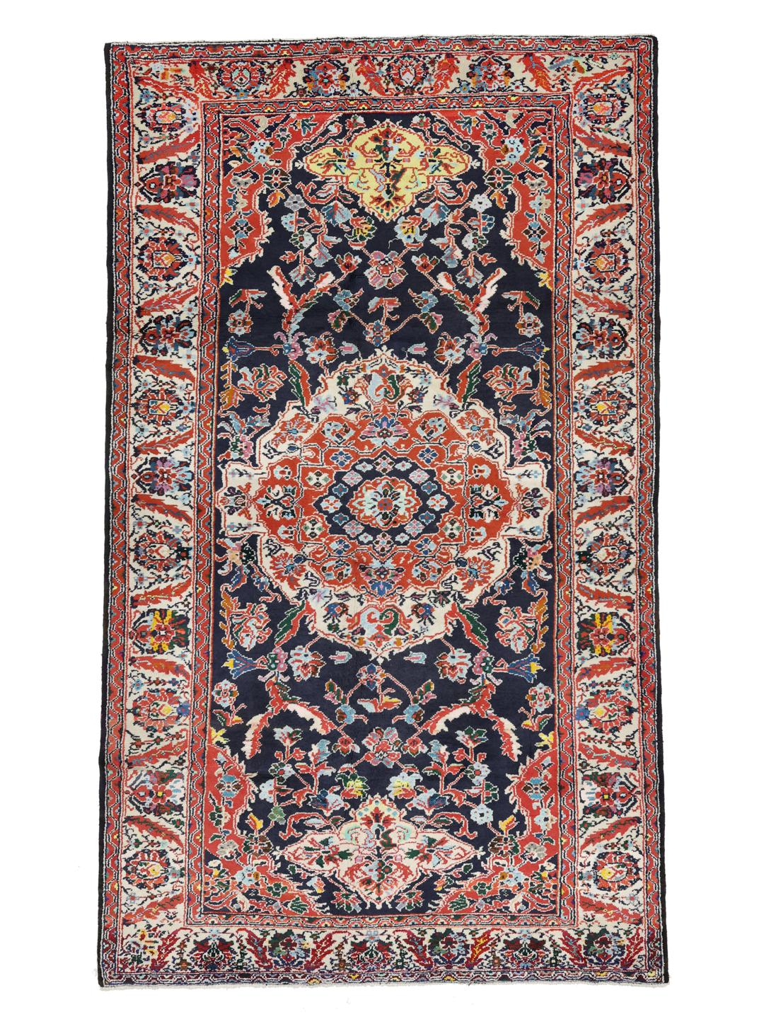 Hand-knotted Ardebil rug from the Middle East with a dark-blue and red floral medallion design.
